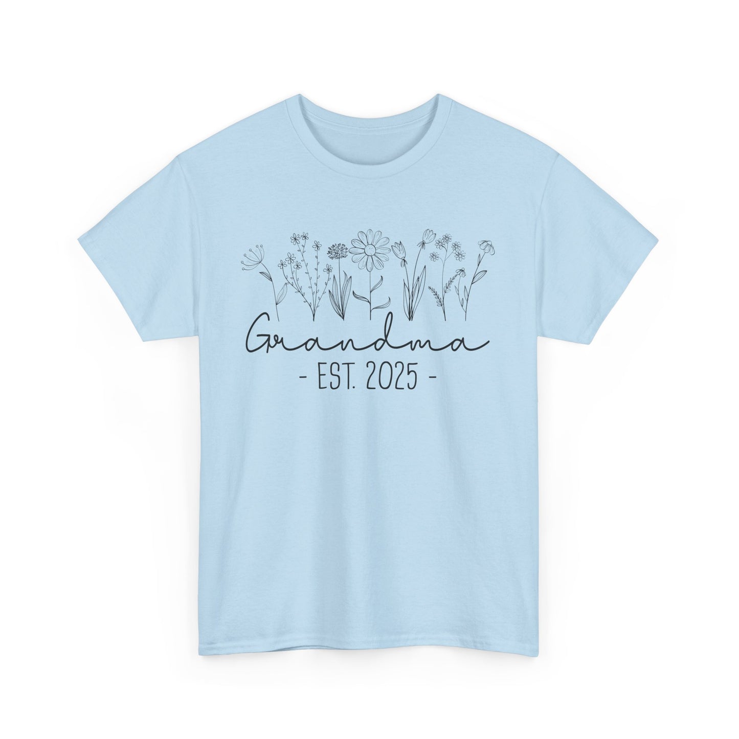 Flatlay of pink ‘Promoted to Grandma 2025’ T‑shirt styled with flowers, ideal pregnancy reveal gift flat presentation.