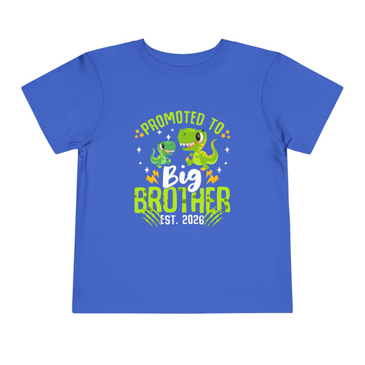 Blue t-shirt with dinosaur graphics and text 'Promoted to Big Brother Est. 2026' on a white background