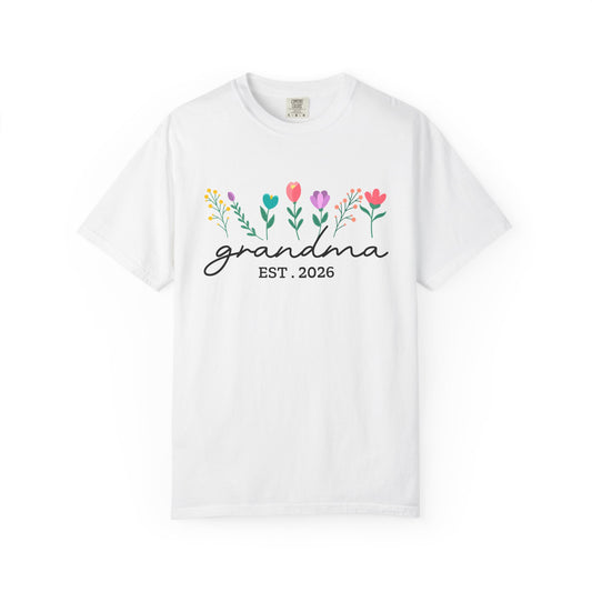 White t-shirt with floral design and 'grandma EST. 2026' text on a white background