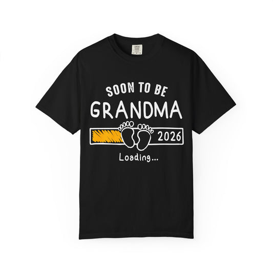 Black t-shirt with 'Soon to be Grandma 2026 Loading...' text and footprints on a white background